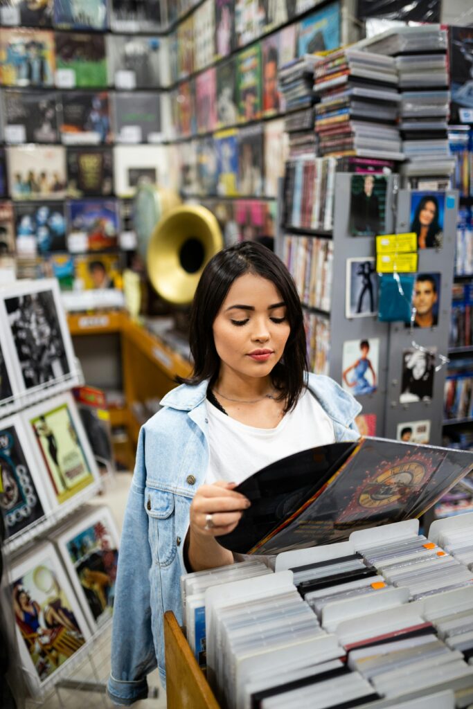 Woman browsing records in a vibrant São Paulo music shop with diverse album covers.